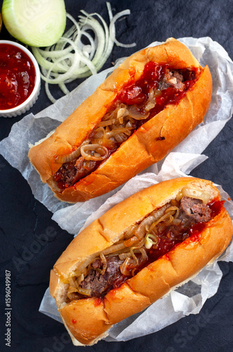 two traditional South African Boerewors rolls on black