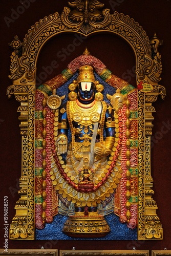 Golden statue of Lord Balaji (Venkateswara), Hindu deity in traditional ornaments, Tirupati temple, India. Hinduism, religion, spirituality concept.