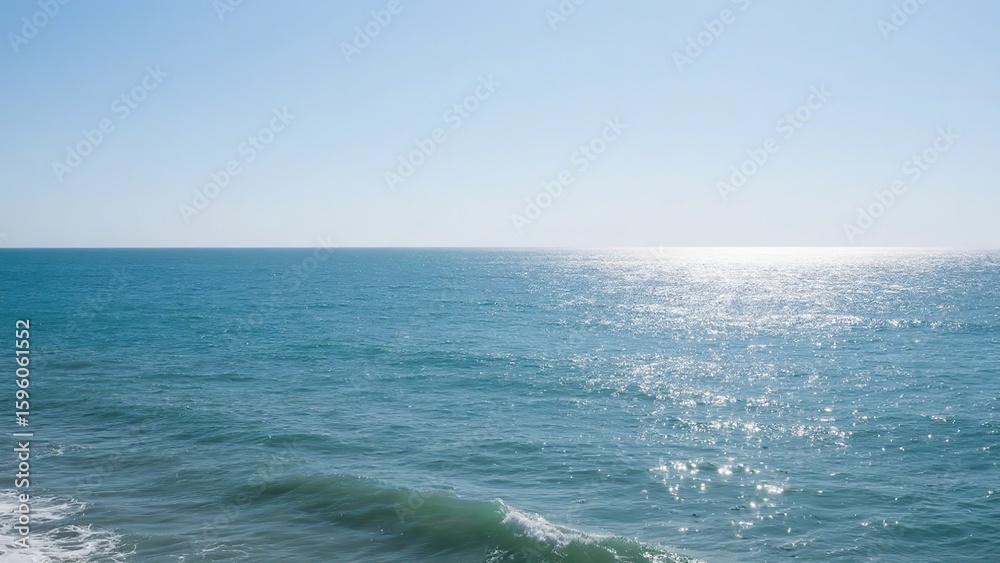 Fototapeta premium Calm Ocean Waters Reflecting Sunlight Under a Clear Sky