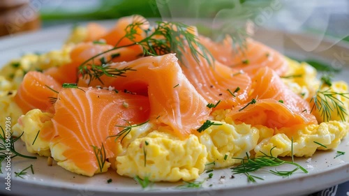 Artfully plated scrambled eggs with smoked salmon and dill, representing a sophisticated culinary dish