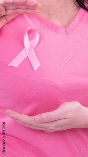 Wallpaper Mural Video of midsection of caucasian woman wearing pink cancer awareness ribbon, with pink background Torontodigital.ca