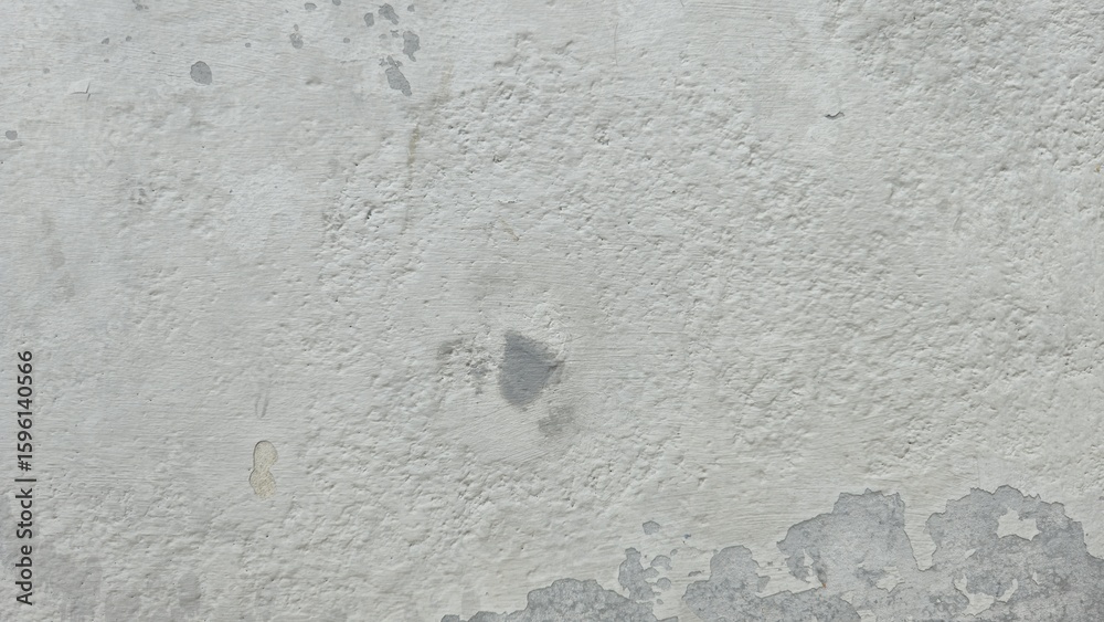 Fototapeta premium Peeling paint on the wall. White peeling paint on the wall. Old concrete wall with cracked flaking paint. The white painted brick wall surface has scratches and peeling paint.
