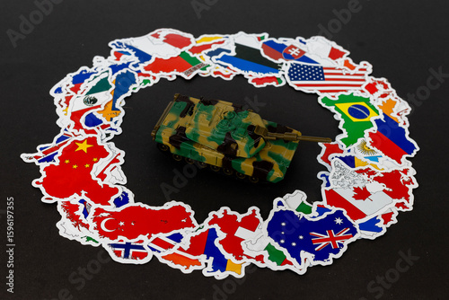 Cuadro en lienzo Military Toy Tank on World Flags on Black Background