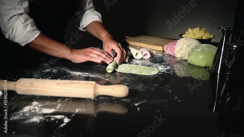 Witness the skillful creation of homemade Italian pasta. Vibrant three-color dough is meticulously rolled and prepared for delicious ravioli, highlighting traditional culinary art and fresh food.