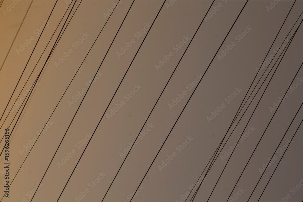 Obraz premium This is a closeup view that showcases a row of power lines situated on a buildings structure, emphasizing their detail and presence
