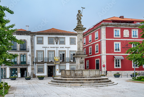 A monument in front of stylish buildings in the town of Viana do Castelo, Portugal