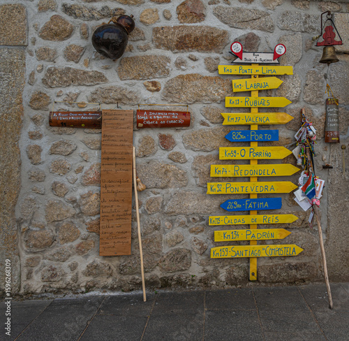 Wooden plaques and signposts showing distances from Viana do Castelo to various destinations along the Caminho de Santiago.