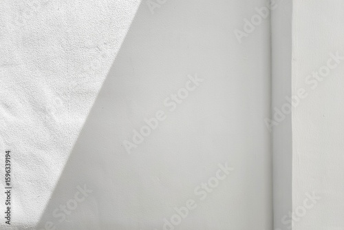White Concrete Wall with Light, Shadow, and Pole.