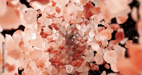 Himalayan pink salt is fallingin a super slow motion. Pink Himalayan salt is up to twenty times more expensive than table or sea salt. Shot on super slow motion camera 1000 fps.