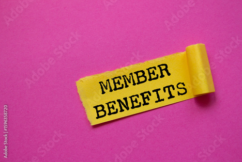 Member benefits message written on ripped torn yellow paper piece on pink background. Conceptual member benefits symbol. Copy space.