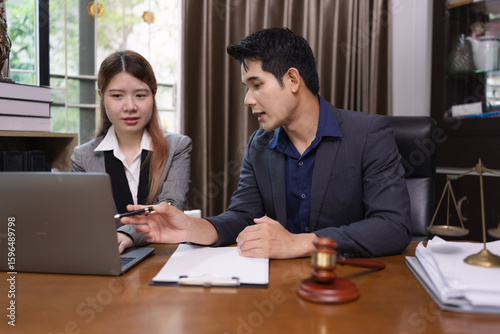 Two Lawyer with Document Paper and Hammer on Wood table,  Judge's Gavel, Law, Justice Symbol, Agreement and Partnership Concept,