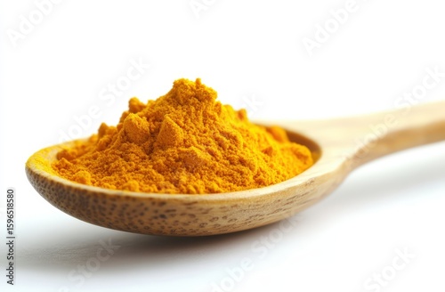 A wooden spoon filled with bright yellow-orange turmeric powder on a white background.