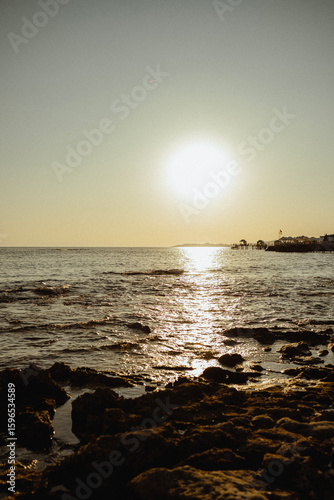 Fototapeta Naklejka Na Ścianę i Meble -  ocean shore at sunset with sun and summer evening atmosphere. Turkish culture and nature. Dream and travel to seaside vacation with waves and sea breeze