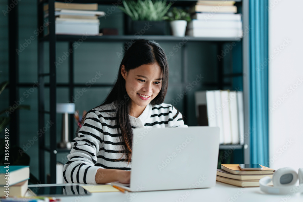Asian female student learning online at home with laptop Asian female student learning online at home with laptop