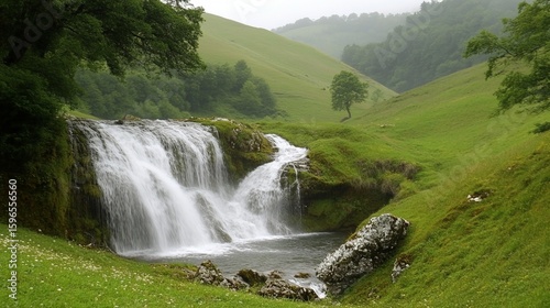 Serene waterfall cascading down mossy rocks into a tranquil pool, nestled within lush green valley