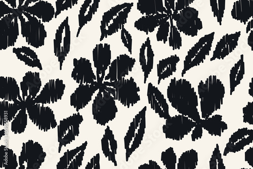 Seamless black and white ikat floral pattern with bold abstract flowers and leaves in embroidery-inspired style for fabric, textile print, fashion design, and home decor.