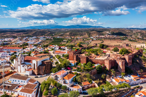 View of Silves town buildings with famous castle and cathedral, Algarve region, Portugal. Walls of medieval castle in Silves town, Algarve region, Portugal.