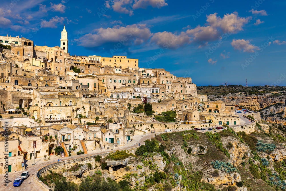 Obraz premium Panoramic view of the ancient town of Matera (Sassi di Matera) in a beautiful autumn day, Basilicata, southern Italy. Stunning view of the village of Matera. Matera is a city on a rocky outcrop.