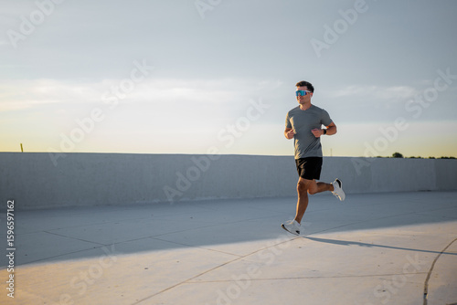 Jogger enjoying an evening run along a sun-kissed pathway at sunset
