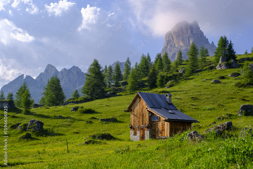 Obraz premium Hut in Passo Giau and mountain of Averau, hiking in the Alta via 1, in the Dolomites of Italy.