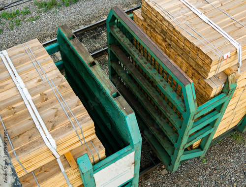 A fragment of a train carrying processed wooden boards