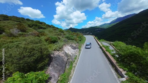 Drone view of serpentine asphalt road in mountainous area in Italian Alps. cars are going on a trip. Green planet. Tourism. Transport. Dangerous road. Italy Bergamo 20.08.2025