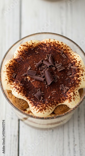 Delicious Tiramisu Dessert in Glass Bowl, Close-Up View, Cocoa Powder and Chocolate Shavings