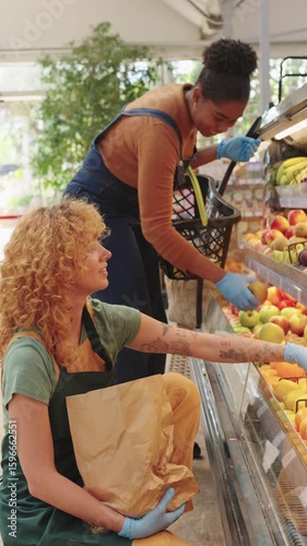 Fruit seller picking mangoes for customer in slow motion