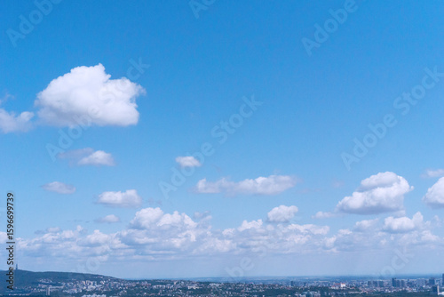 Photography View of Bratislava skyline with lush green landscape and cumulus clouds in blue sky