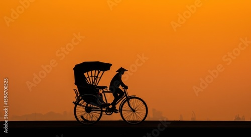 Silhouette of a cyclo at sunset