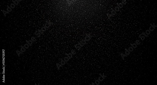 Fototapeta Naklejka Na Ścianę i Meble -  A dark, textured black background with subtle speckles of light