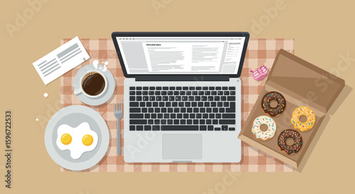 Cozy workspace with laptop and breakfast on checkered tablecloth