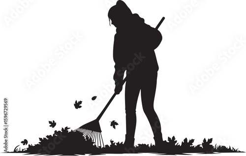 Woman raking leaves during autumn season