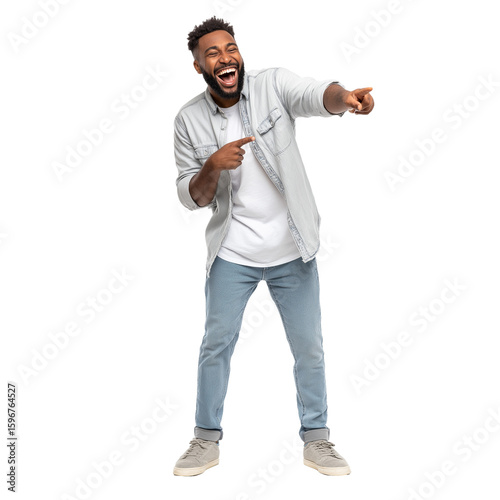 Man laughing while pointing with both hands, wearing casual light denim shirt and jeans, expressing amusement and joy in full body pose