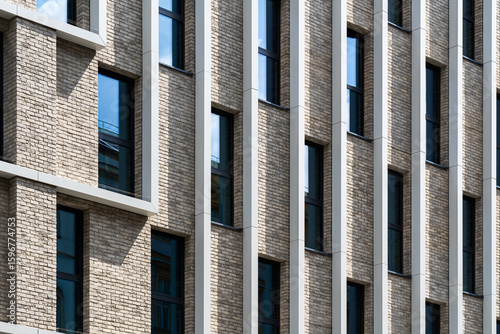 Brick and aluminum facade with vertical rhythm and light play