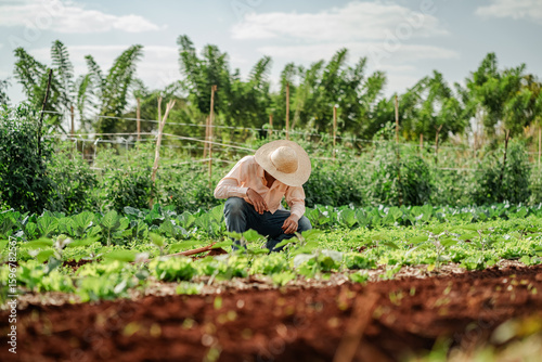 Farmer Tending to Crops in a Lush Green Field
