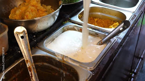 Pouring Fresh Curd in a Bowl at an Indian Street Food Cart