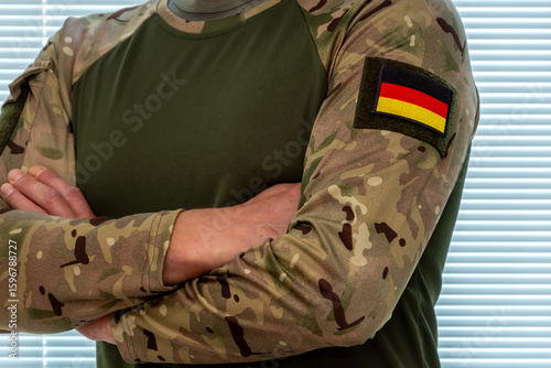 German flag on the sleeve of camouflage uniforms. A symbol of military affiliation and patriotism.