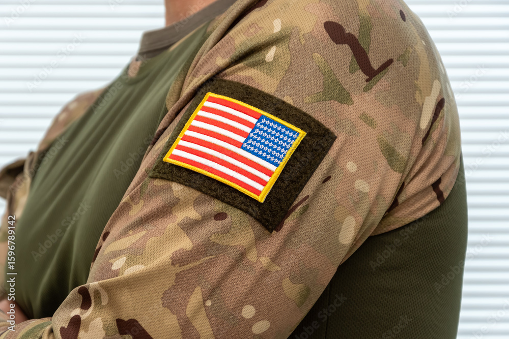 Obraz premium American flag on military uniforms with camouflage. A symbol of national identity and defence.