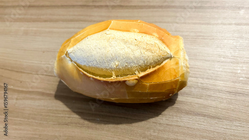 Small french bread loaf resting on wooden table