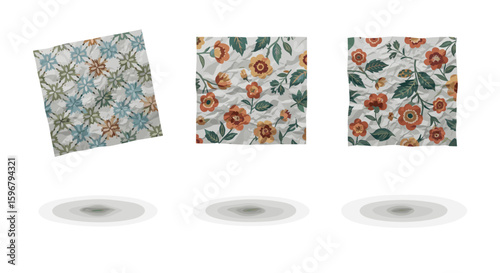 Three floral patterned cloths hovering above their respective shadows on a white background image view