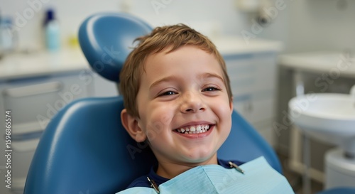 Smiling boy dental chair blue bib dentist office. Pediatric oral health care treatment concept. Medical dental services banner