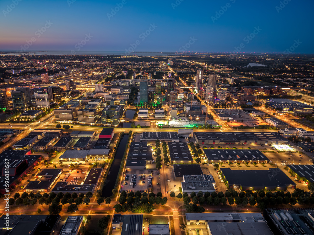 Naklejka premium Amsterdam skyline with illuminated stadium and roads at dusk
