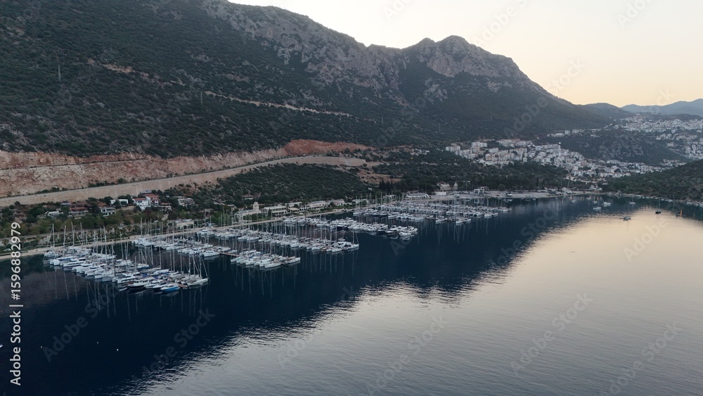 Obraz premium Coastal mountain landscape, sea resort yachts, golden hour