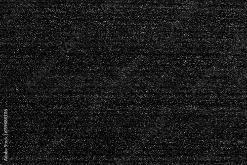 Black porous foam padding with layered structure and soft textured surface. Protective packaging material. Abstract dark background