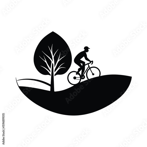 Silhouette of cyclist riding bicycle on hillside