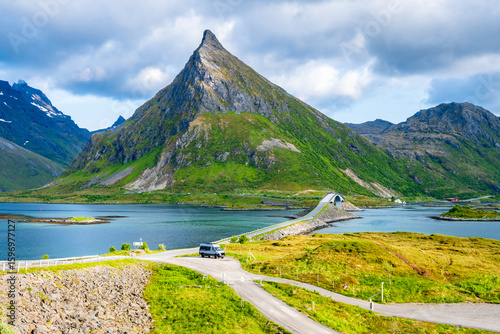 Road over Fredvang bridge and view of sea and Volandstinden mountain, Lofoten Islands, Norway