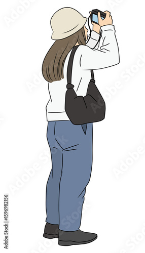デジタルカメラで撮影する若い女性