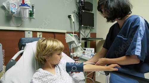 Pediatric doctor in hospital room with little boy 