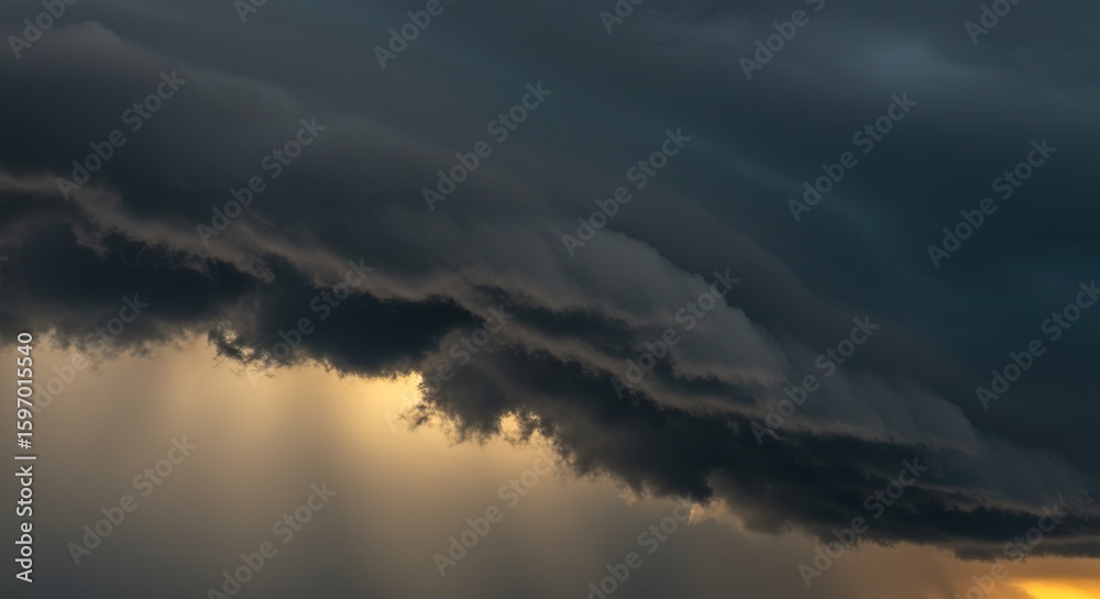 Fototapeta premium Dark storm clouds with sunlight breaking through creating a dramatic sky.